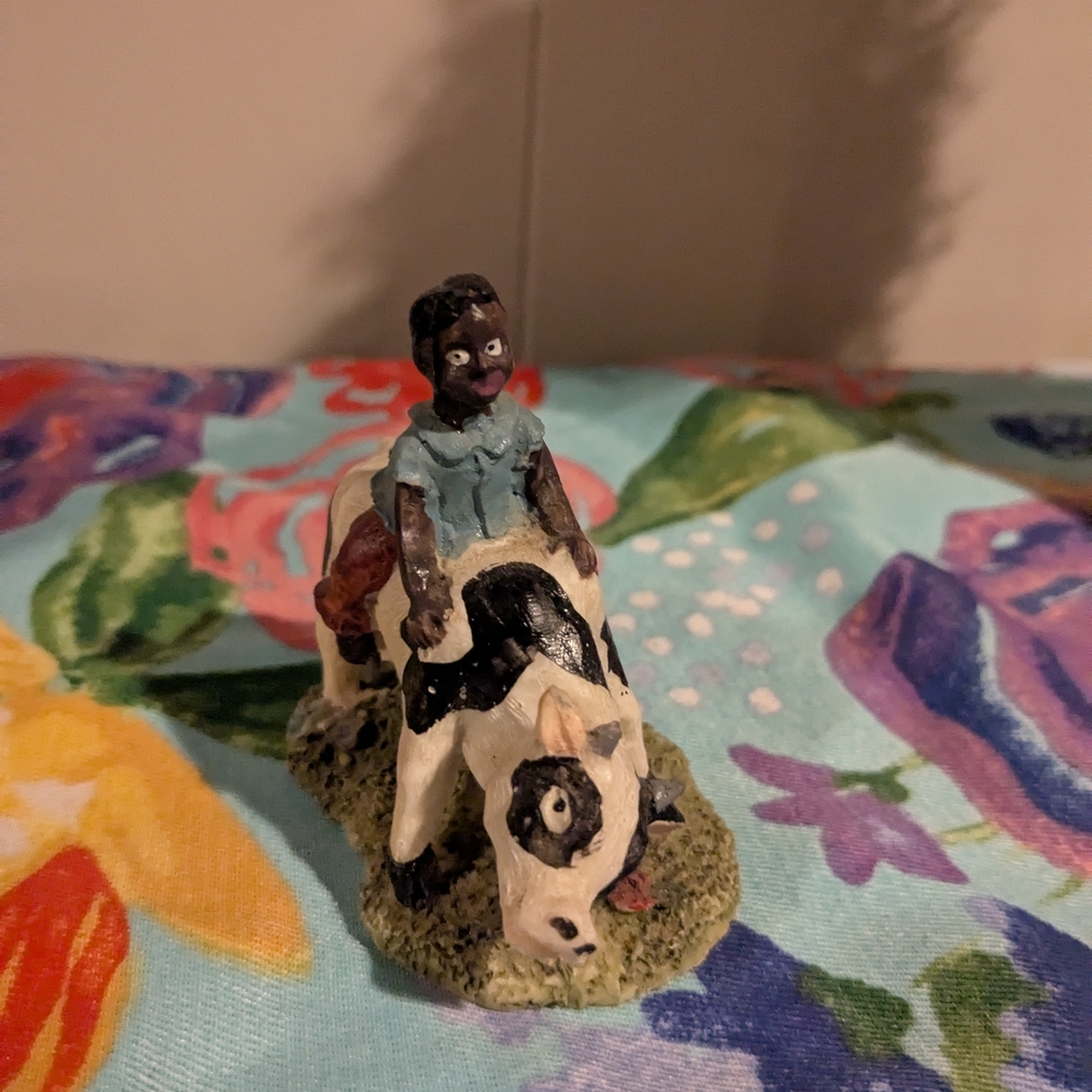 Hand-Painted Figurine with Child on Cow
